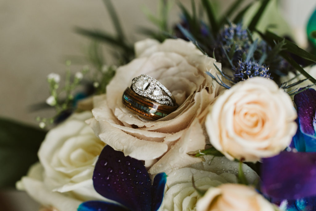 wedding rings and colorful bridal bouquet