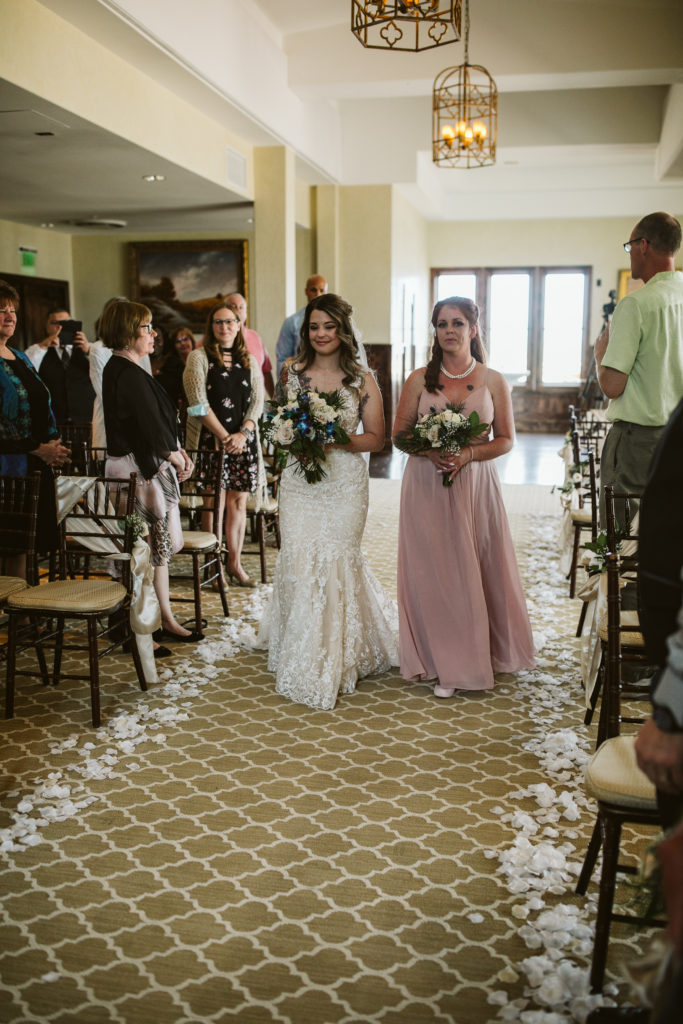 Bride escorted down wedding aisle Colorado wedding