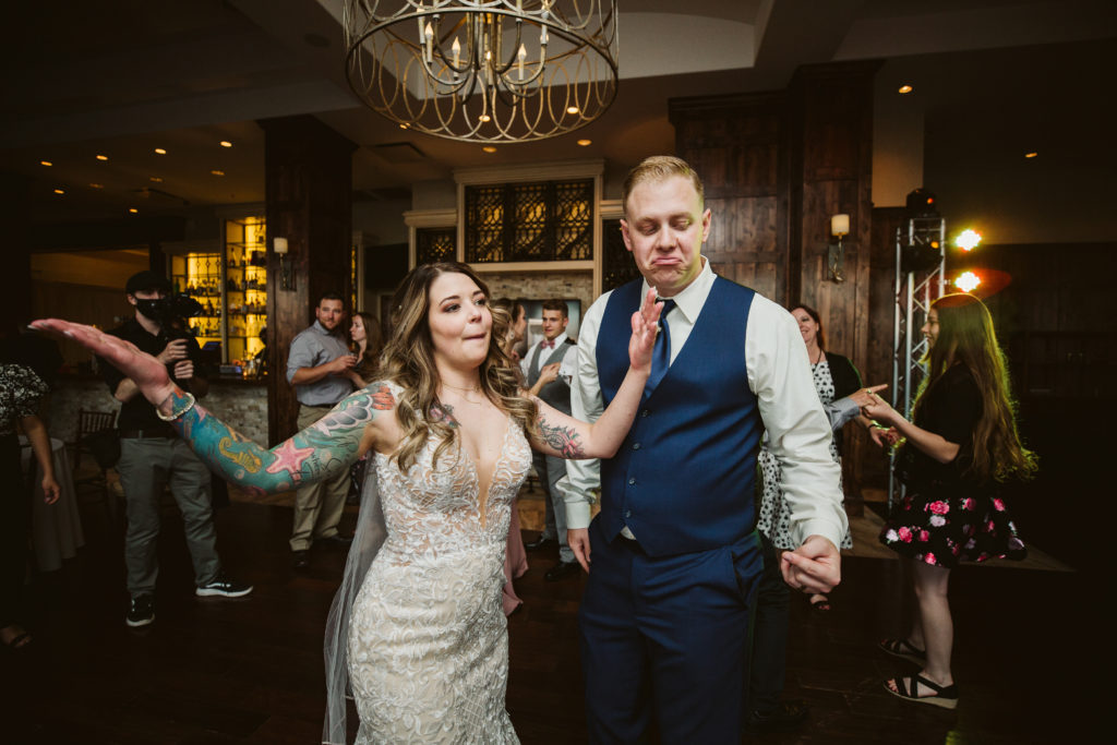 groom and bride dancing at indoor ballroom reception